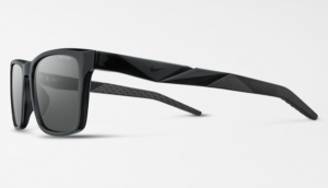 A side profile view of the Nike Radeon lifestyle sunglasses in black. The frames feature a bold, contemporary silhouette with geometric, faceted detailing along the temples and a subtle Nike swoosh. The lenses are dark and square-shaped.