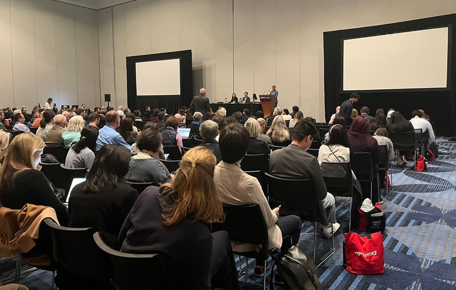 Packed conference room at ARVO 2026 with attendees seated facing a podium and presentation screens