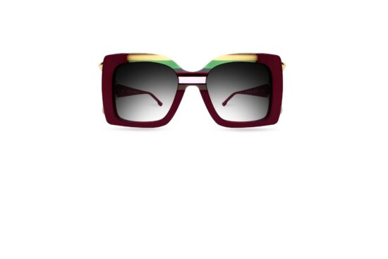 Ultra Limited Torcello sunglasses in deep burgundy acetate with layered colour insertions in yellow, green and red along the upper bridge, gold metal temple detail, and gradient grey lenses. Front-facing product shot on white background.