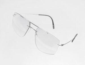 Silhouette The Refined titanium eyeglasses floating against a white background, showcasing the rimless aviator-style frame with an ultra-thin double bridge and slim temples with dark tips