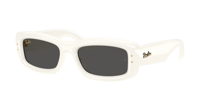 A three-quarter view of the Ray-Ban Kiliane Puffer sunglasses (Model 0RB4944). The sunglasses feature a glossy, solid bone-white rectangular frame with thick, exaggerated proportions and softly rounded edges. The lenses are a solid dark grey, and the wide white temples feature a gold script Ray-Ban logo accompanied by two small gold pins on the frame front.