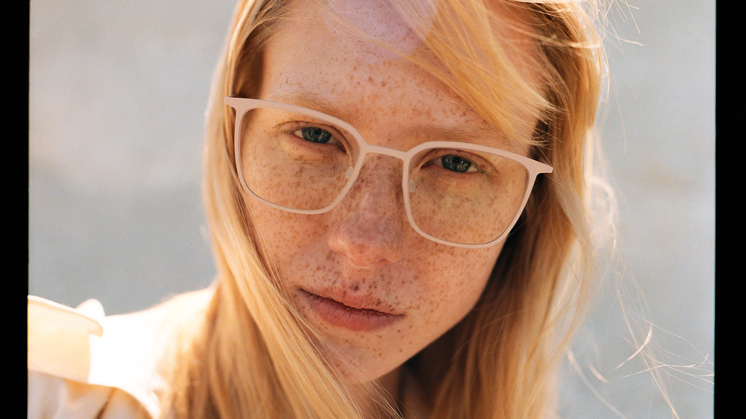 Model wearing Ørgreen NYHAVN eyewear in a soft pink monochromatic colourway.