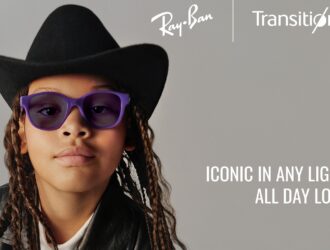 Child wearing purple Ray-Ban glasses with Transitions photochromic lenses and a cowboy hat with text reading Iconic in any light, all day long