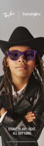 Child wearing purple Ray-Ban glasses with Transitions photochromic lenses and a cowboy hat with text reading Iconic in any light, all day long