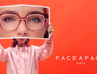 FACE A FACE Paris AW26 MARKER collection banner featuring a model holding a magazine photo of eyes wearing brown acetate glasses against a red background.