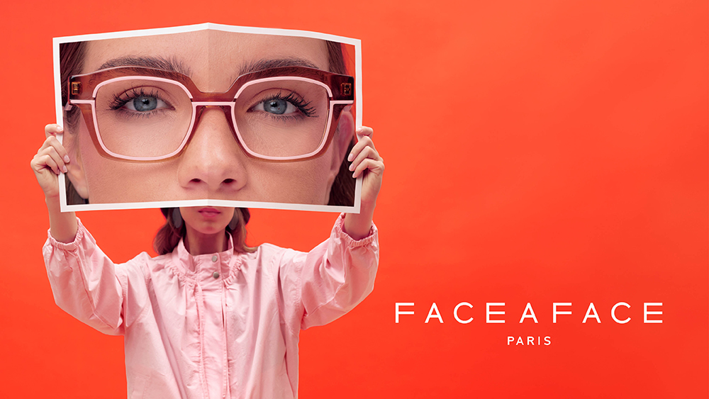 FACE A FACE Paris AW26 MARKER collection banner featuring a model holding a magazine photo of eyes wearing brown acetate glasses against a red background.