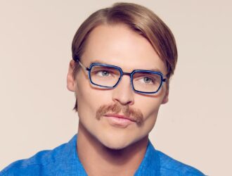 Man wearing blue OGI rectangular eyeglasses with bright blue eye rim accents