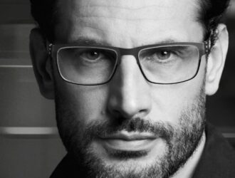 Close-up campaign portrait of a man wearing ic! berlin Thilo rectangular optical glasses.