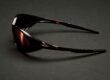 Side view of Cactus Jack x Oakley Eye Jacket Redux sunglasses in exclusive dark colorway on dark surface