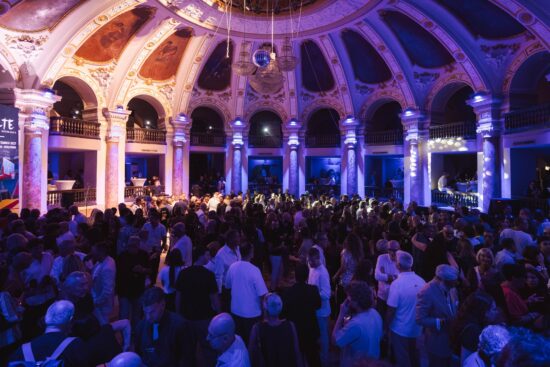 Large crowd gathered inside the illuminated Salone Margherita in Naples for the DaTE 2026 eyewear event.