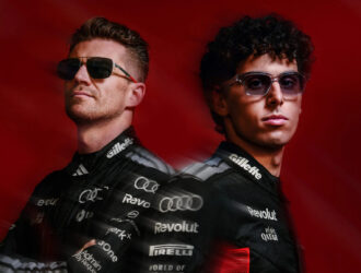 Audi Revolut F1 Team drivers Nico Hülkenberg and Gabriel Bortoleto wearing ic! berlin sunglasses against a dark red background.