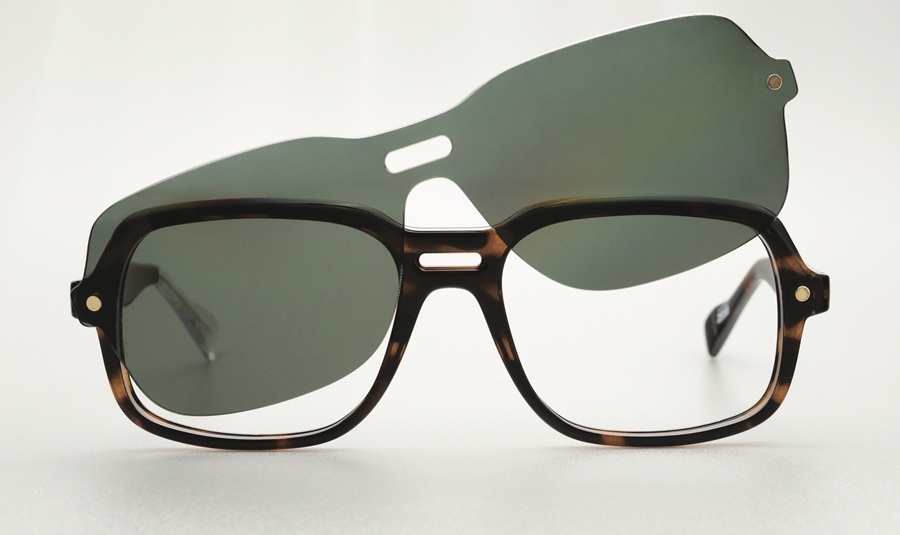 Front view of a 1970s-inspired tortoiseshell acetate frame with a keyhole bridge, demonstrating the detachable magnetic clip-on sun lens as it hovers above the frame.