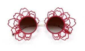 Front flat lay view of the J.F. REY SAKURA limited edition sunglasses, displaying the unique sculptural openwork design around the circular lenses.