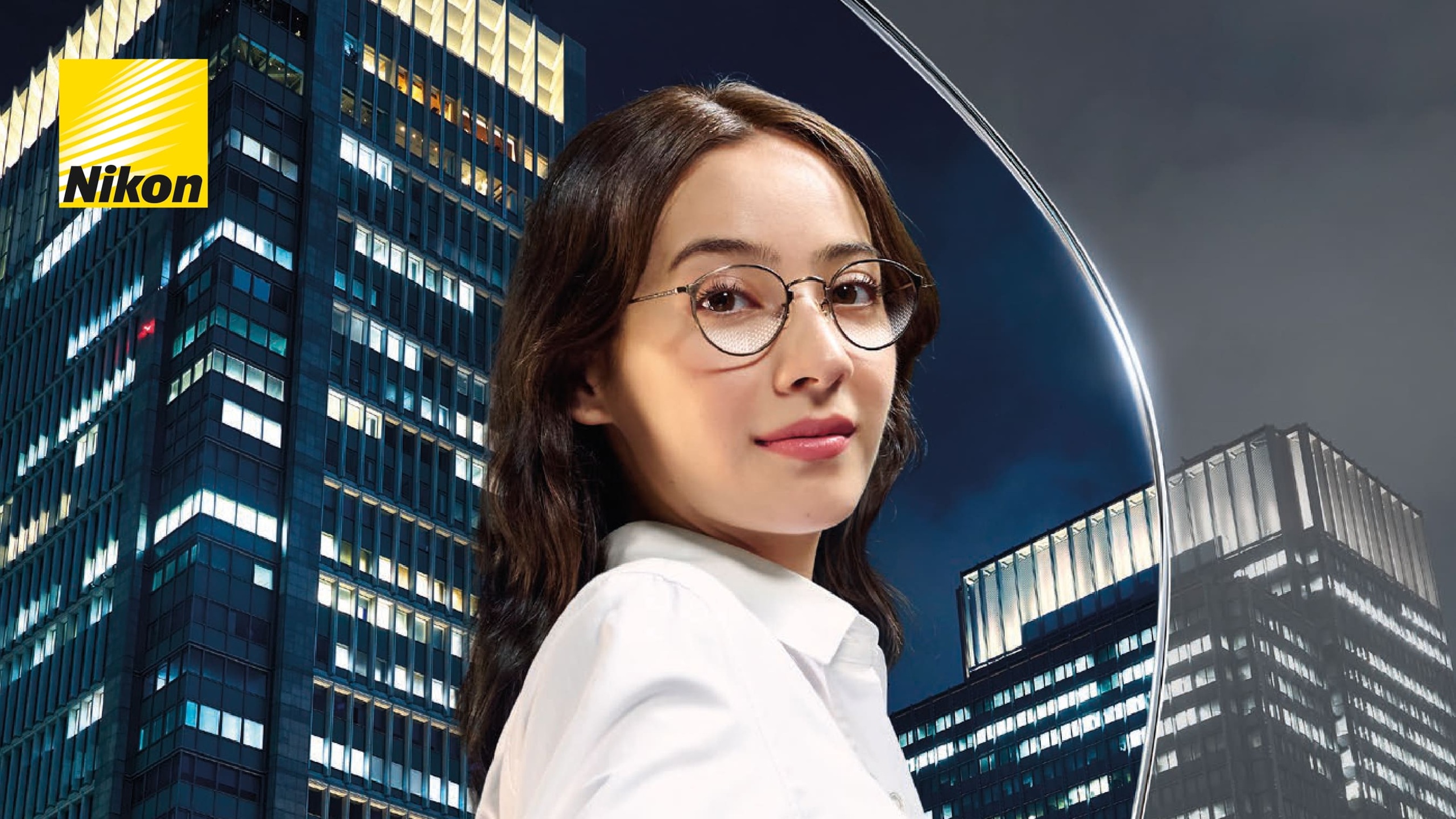 Nikon promotional poster for Z Series Single Vision lenses, featuring a woman with stylish eyeglasses reaching out against a illuminated city skyscraper backdrop, with the headline "EXPERIENCE LIFE WITH HIGHER DEFINITION: A NEW ERA OF SINGLE VISION LENSES."