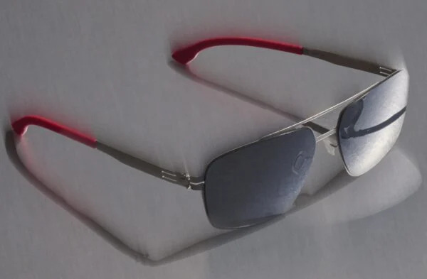 The ic! berlin "Ryan" sunglasses from the Racing Edition, featuring a metal aviator-style double-bridge frame with red temple tips.