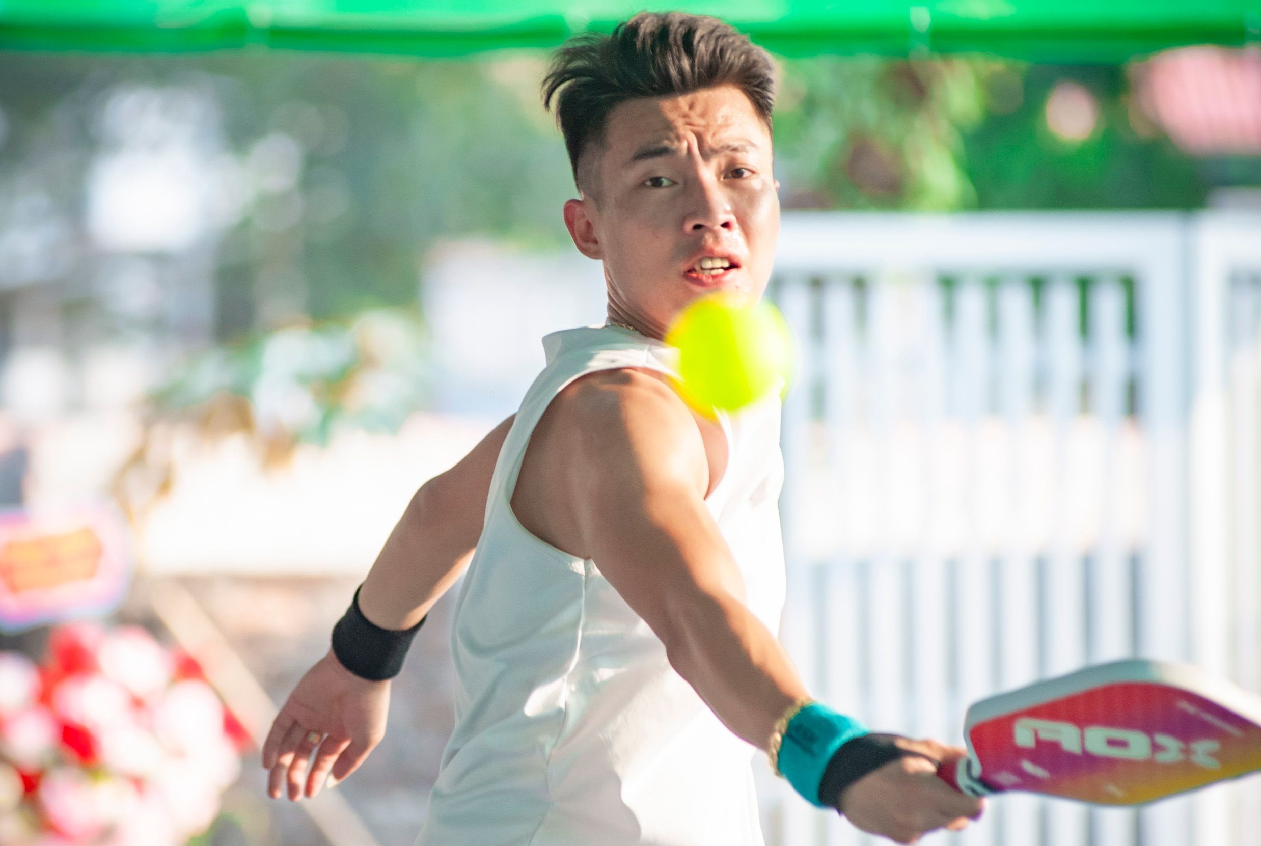 Sports eye safety risk — pickleball player facing ball impact without protective eyewear