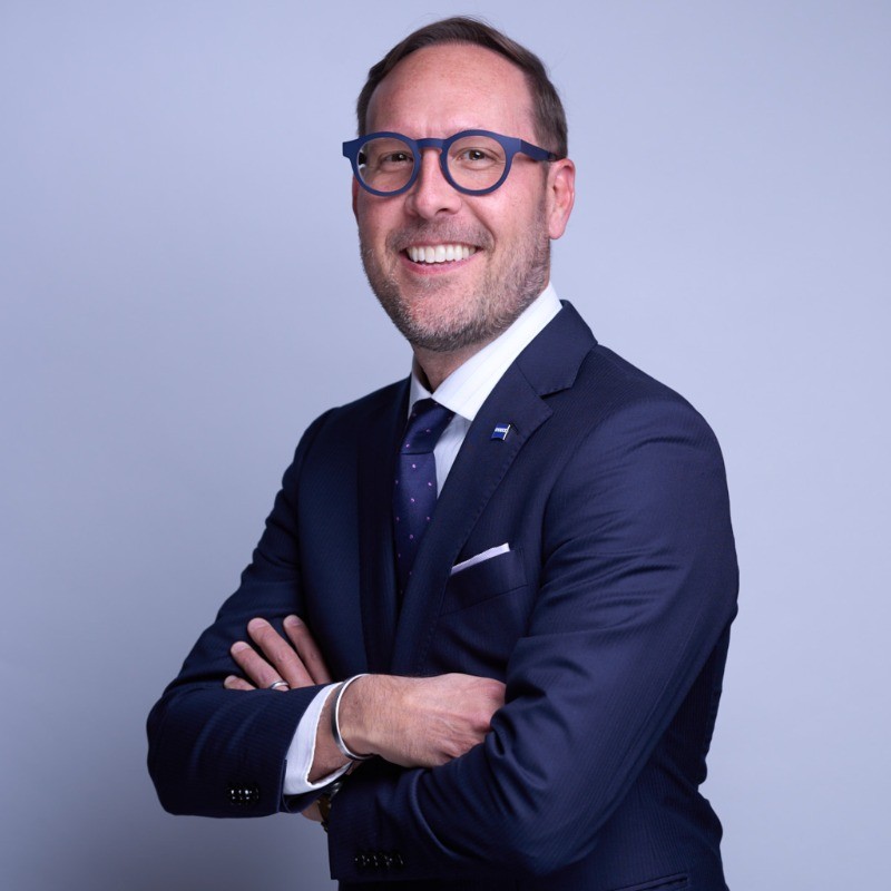 Bryan Rossi, Head of ZEISS Medical Technology Canada, wearing a dark suit and glasses.