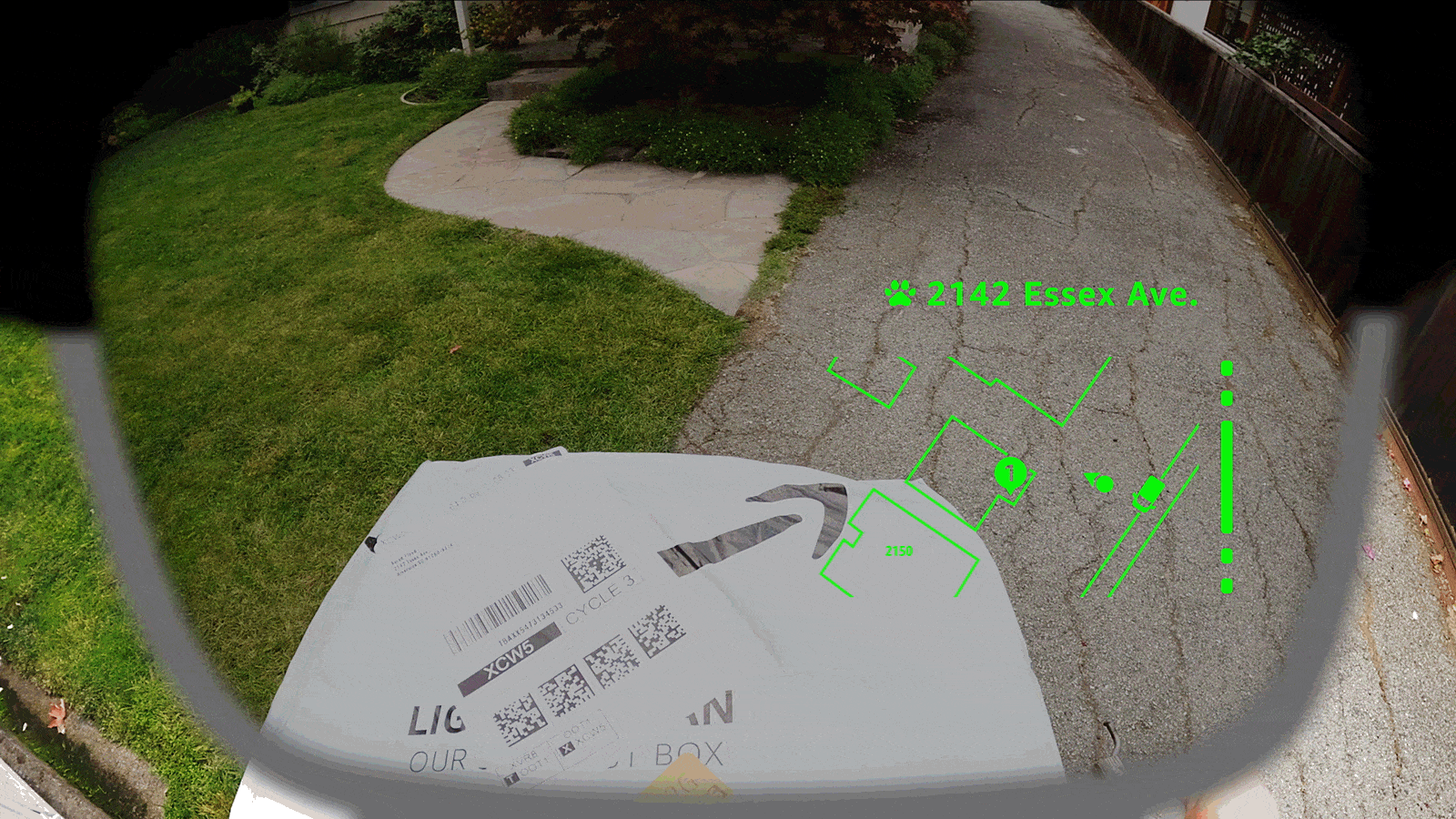 Amazon delivery smart glasses display augmented reality navigation directions and package location details on a residential driveway.