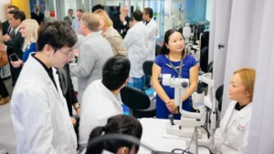 Opticianry students and instructors testing diagnostic equipment at the CooperVision Contact Lens Centre of Excellence at Seneca Polytechnic.