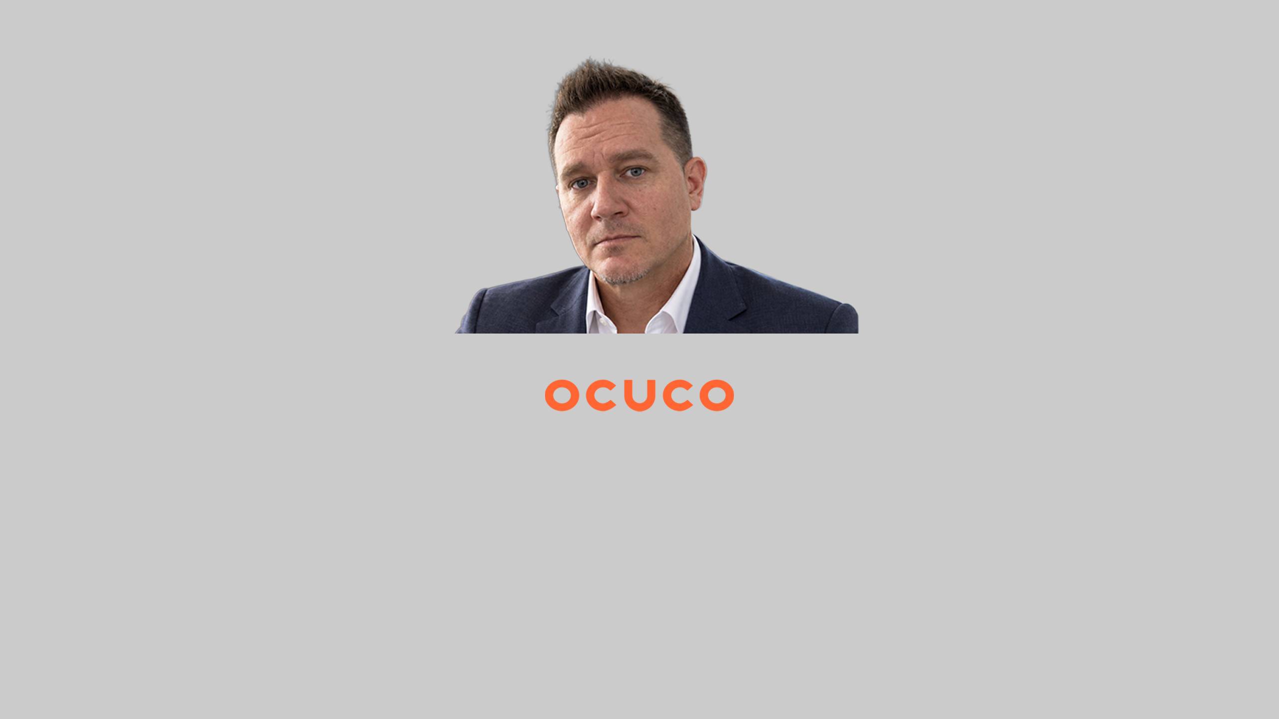 Portrait de Mike Sullivan, cadre responsable des comptes entreprises chez Ocuco, placé au-dessus du logo orange de l'entreprise Ocuco sur fond gris.