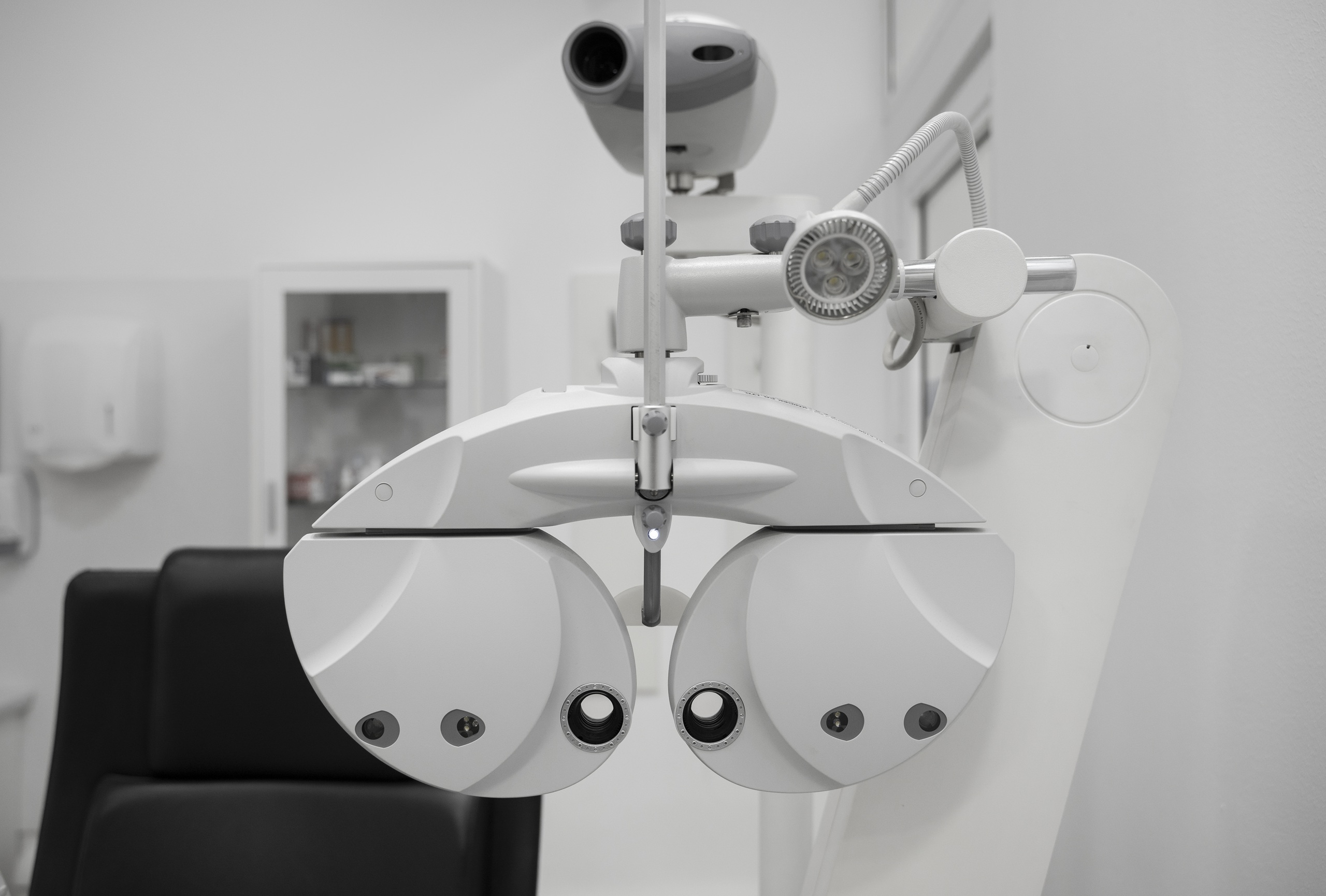 Modern digital phoropter in a clean optometrist examination room.